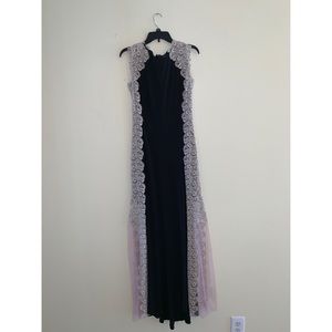 Black gown with gold lace trimming down the sides.